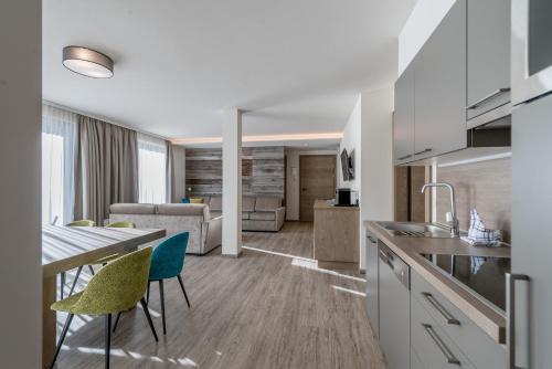 a kitchen and living room with a table and chairs at Top Apart Gaislachkogl in Sölden