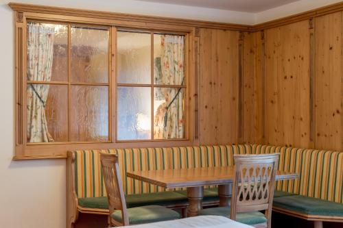 a dining room with a table and chairs and a window at Top Apart Gaislachkogl in Sölden
