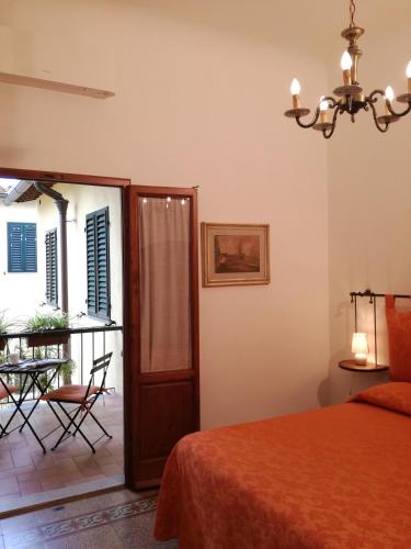 a bedroom with a bed and a table and chairs at Dimora Pieri in Florence