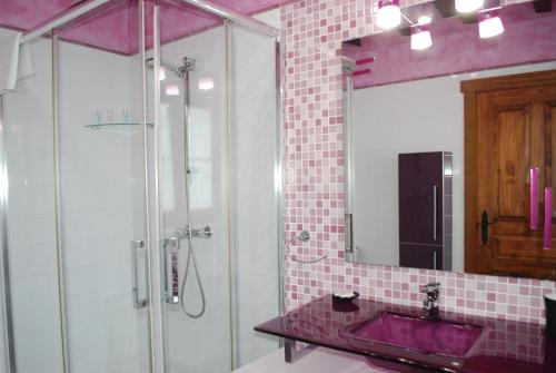 a bathroom with a glass shower and a sink at Posada La Fabula in Santillana del Mar
