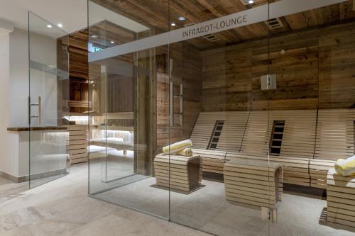 a room with wooden walls and a glass wall at Top Apart Gaislachkogl in Sölden