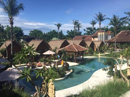 a resort with a swimming pool and a resort at Paradesa Living in Gili Trawangan
