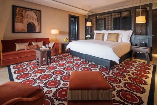 a hotel room with a bed and a couch at Fairmont Royal Palm Marrakech in Marrakech