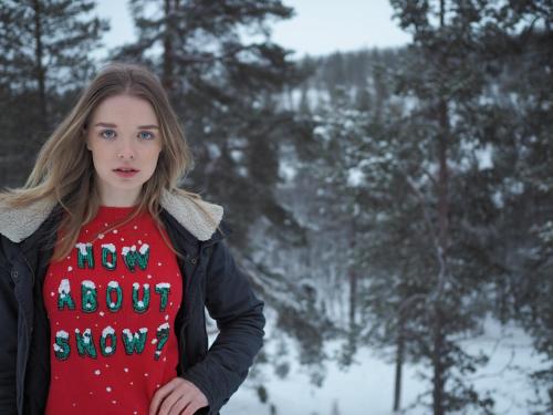 a woman wearing a red christmas shirt at Villas Karhunpesä in Saariselka