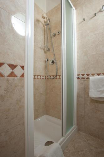a shower with a glass door in a bathroom at Hotel Gaby in Rimini