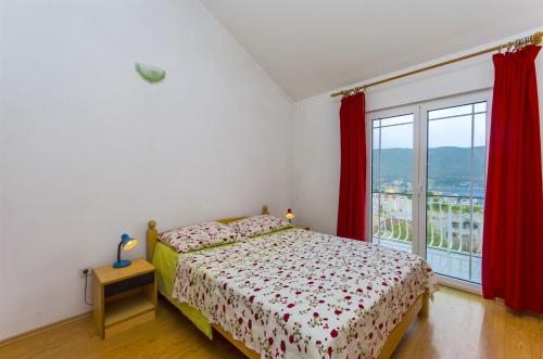 Postel nebo postele na pokoji v ubytování Apartments Kata
