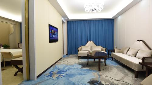 a living room with a couch and a table at Dunhuang Hotel in Dunhuang
