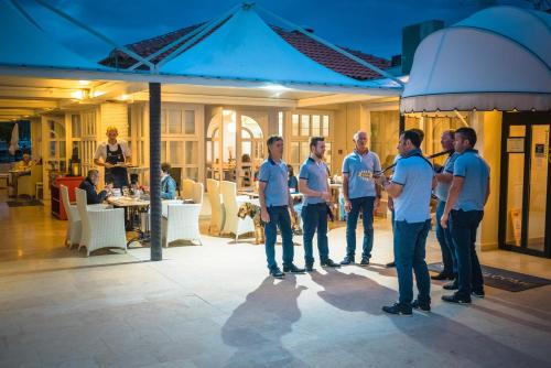 a group of men standing together in a room at Floating Holiday Home in Punat
