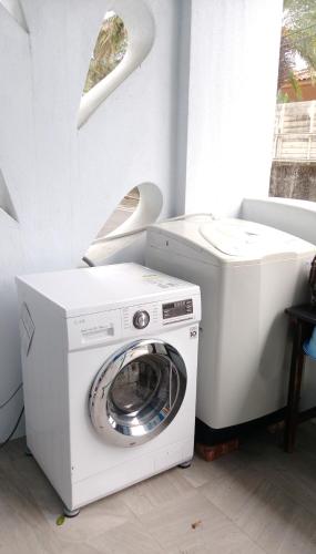 a white washer and dryer in a room at Ktzyx in Nanwan