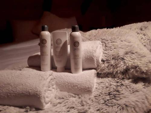 two bottles ofodorizers sitting on a pile of towels at Lodge House Tara in Kolašin