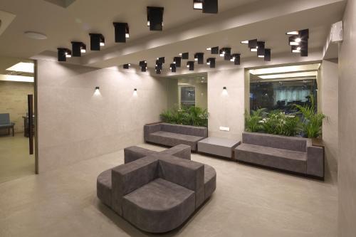 a lobby with a chair in the middle of it at Hotel Carrefour in Ahmedabad