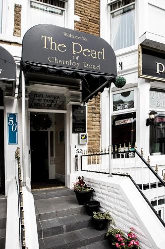 a restaurant with an awning on the front of a building at Pearl Hotel in Blackpool
