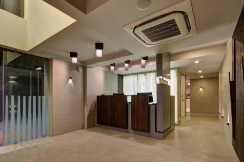 a corridor of a hospital lobby with a ceiling at Hotel Carrefour in Ahmedabad