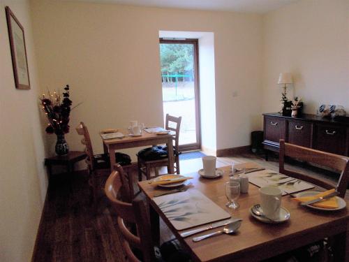 a dining room with a table and chairs and a table and a dining room at Forest View in Fraserburgh