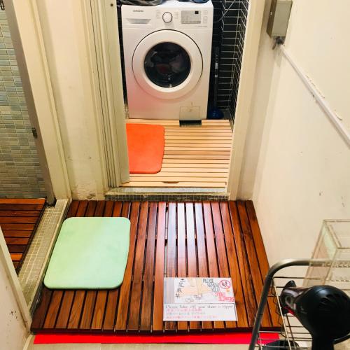 a washer and dryer in a room with a washing machine at Wontonmeen in Hong Kong