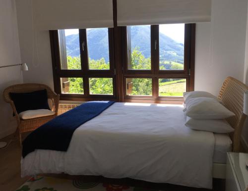 a bedroom with a bed and a large window at Casa Rural Balerdi in Azcárate