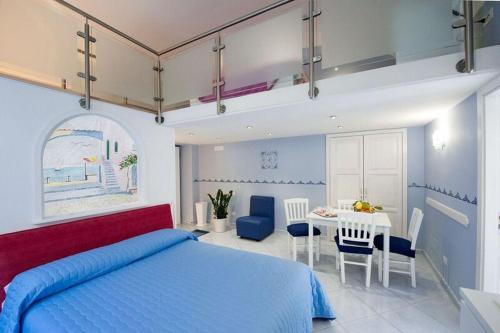 a bedroom with a bed and a table with chairs at Casa Amore S Lucia in Amalfi