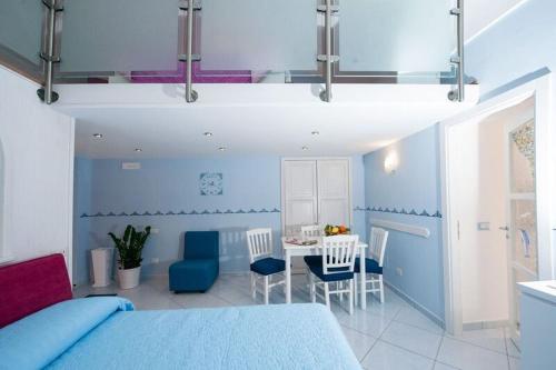 a bedroom with a bed and a table and chairs at Casa Amore S Lucia in Amalfi
