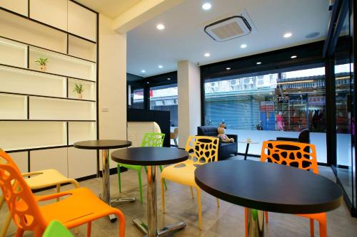 a restaurant with two tables and colorful chairs at Free wind B&B in Taitung City