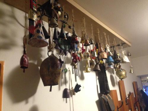 a wall with a bunch of bells hanging on a wall at Ski apartmány Spiežovec Donovaly in Donovaly