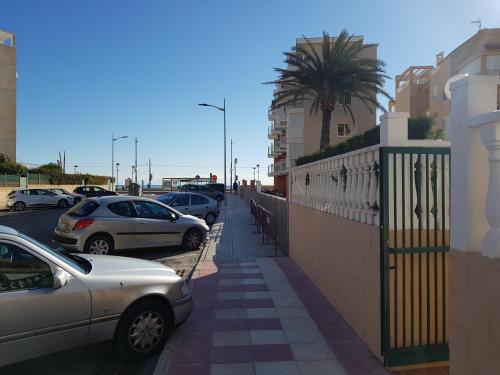 a street with cars parked in a parking lot at Atico en playa muchavista san juan Estrella in El Campello