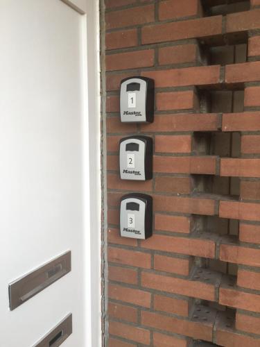 a brick wall with three toasters on it at Apartment Gronau in Gronau