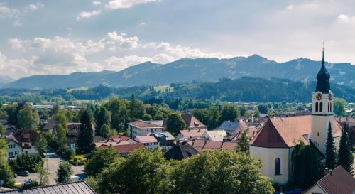 a view of a town with a clock tower at Sanosueno in Sonthofen