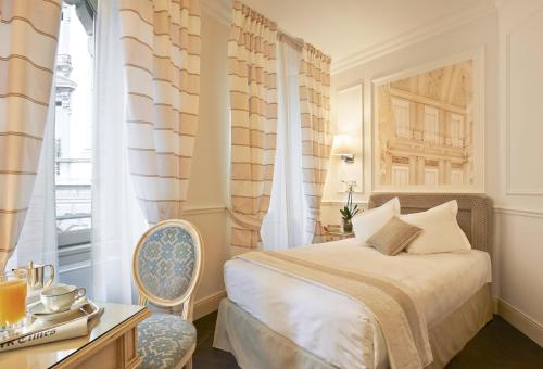um quarto com uma cama, uma cadeira e uma janela em Albergo Terminus em Como