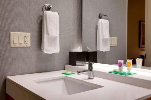 a bathroom with a sink and a mirror and towels at Hyatt Place Park City in Park City