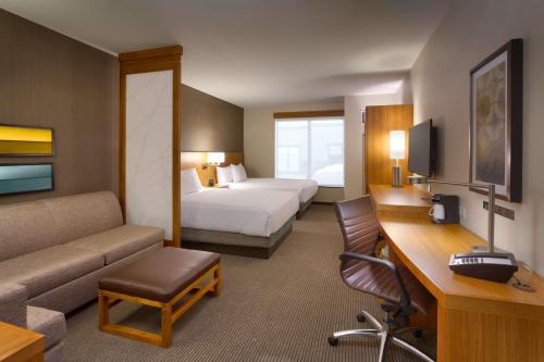 a hotel room with a bedroom with a bed and a desk at Hyatt Place Park City in Park City