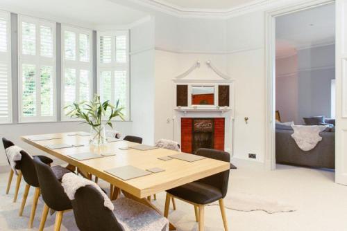 a dining room with a wooden table and chairs at Ramsay Gardens - Grand 4-Bedroom Apartment Next To Castle in Edinburgh
