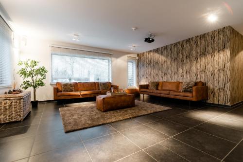 a large living room with couches and a table at Casa Lavanda in Zottegem