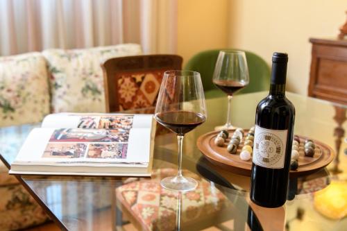 a bottle of wine and two glasses on a table at Villa Socini in Siena