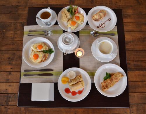a table topped with plates of food on a table at Hata Hutsula in Mykulychyn