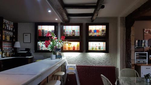 a bar with a vase of flowers on a counter at Hotel Colegiata in Santillana del Mar