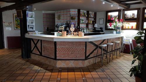 a bar in a restaurant with stools at Hotel Colegiata in Santillana del Mar