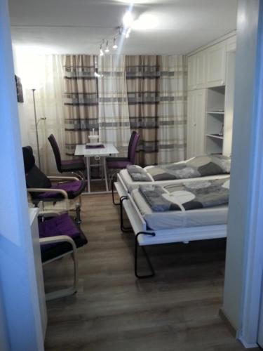 a bedroom with two beds and a table and chairs at Flims113 in Flims