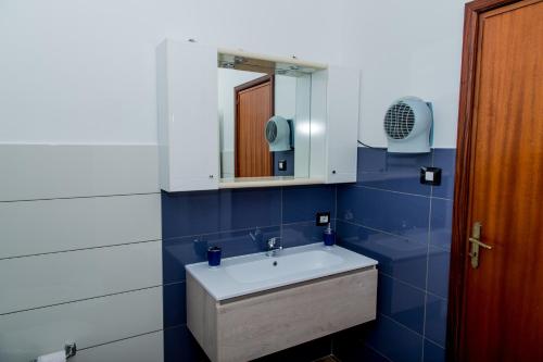 a bathroom with a white sink and a mirror at Sealand in Nunziata