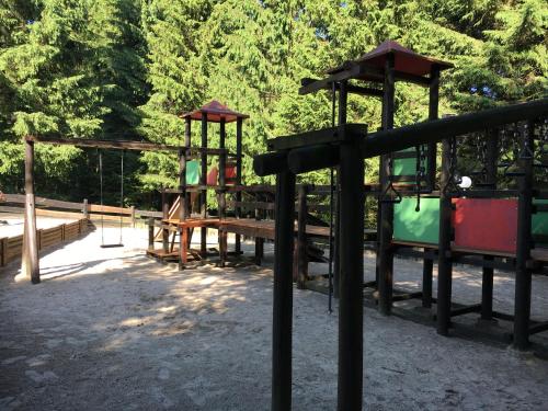 a park with a playground with a swing at Moderne und komfortable Appartements im Ferienpark Hahnenklee in Hahnenklee-Bockswiese