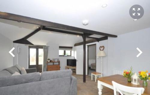 a living room with a couch and a table at The Tollgate Inn in Bradford on Avon