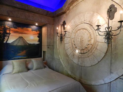 a bedroom with a bed with a painting on the wall at The Roxbury in Roxbury