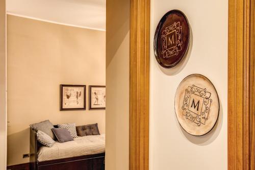 a room with a couch and a clock on the wall at Spanish Steps Miracle Suite in Rome