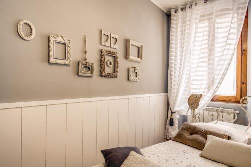 a bedroom with a bed and some pictures on the wall at Spanish Steps Miracle Suite in Rome
