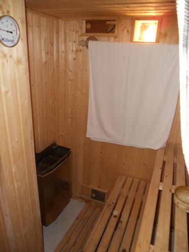 a wooden cabin with a window and a curtain at Chalupa Podhradí in Jiřetín pod Jedlovou