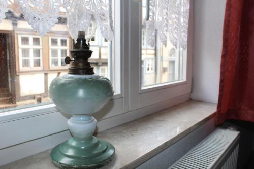 a green vase sitting on a window sill at Alter Topf in Quedlinburg