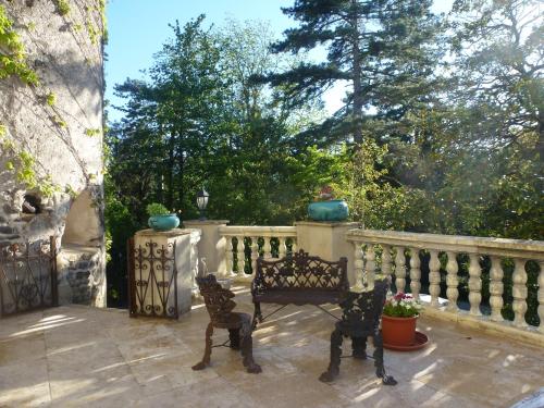 a patio with a bench and a fence at Chateau de Mauras in Chomérac