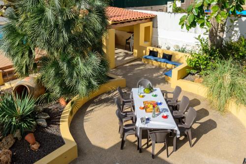 a table and chairs in a patio with a table and chairsktop at Villa Can Giovanni in Sant Jordi