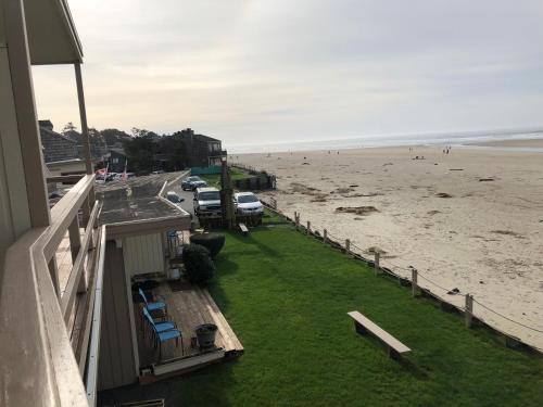 a view of the beach from the balcony of a house at Webb's Scenic Surf in Cannon Beach