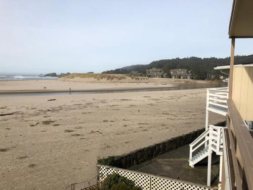 a view of the beach from the porch of a beach house at Webb's Scenic Surf in Cannon Beach