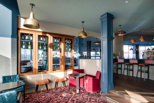 a restaurant with tables and chairs and a bar at Metro Apartments Dublin Airport in Dublin
